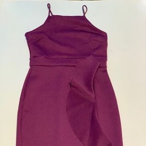 Purple dress has a small tiny leg slit